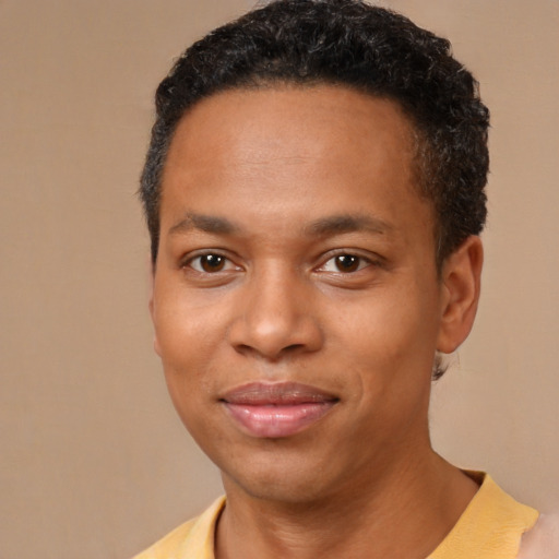 Joyful black young-adult male with short  brown hair and brown eyes