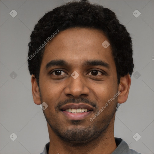 Joyful black young-adult male with short  black hair and brown eyes