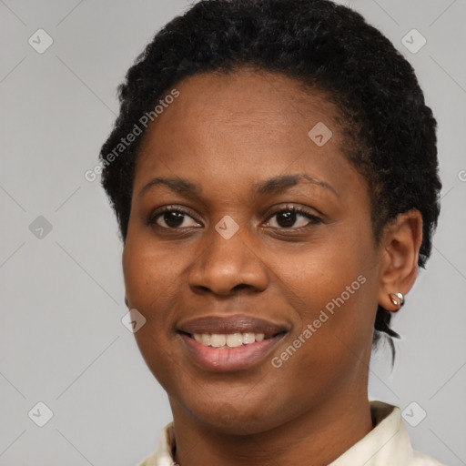 Joyful black young-adult female with short  black hair and brown eyes