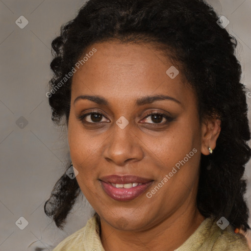 Joyful black adult female with medium  brown hair and brown eyes