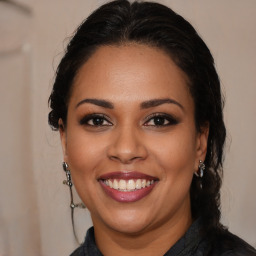 Joyful latino young-adult female with long  brown hair and brown eyes