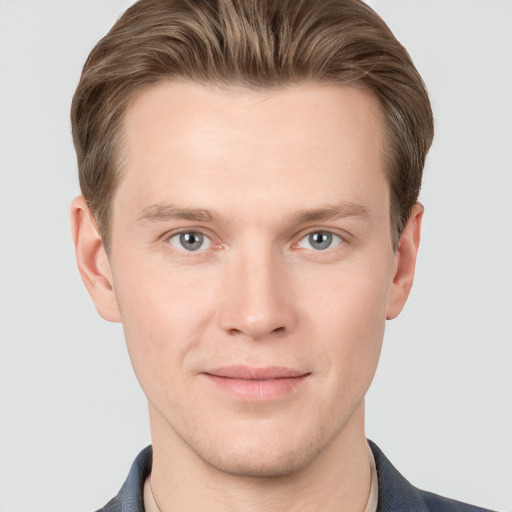 Joyful white young-adult male with short  brown hair and grey eyes