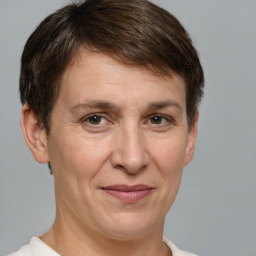 Joyful white adult female with short  brown hair and grey eyes