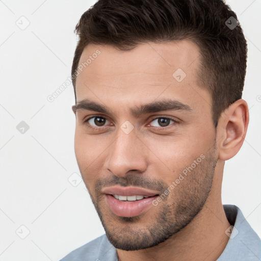 Joyful white young-adult male with short  brown hair and brown eyes