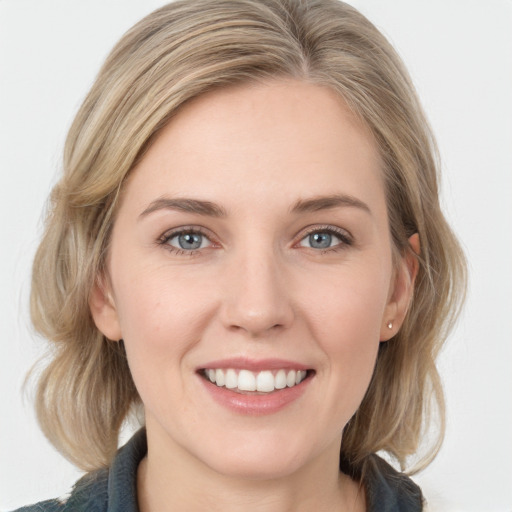 Joyful white young-adult female with medium  brown hair and blue eyes