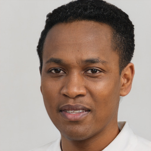 Joyful black young-adult male with short  black hair and brown eyes