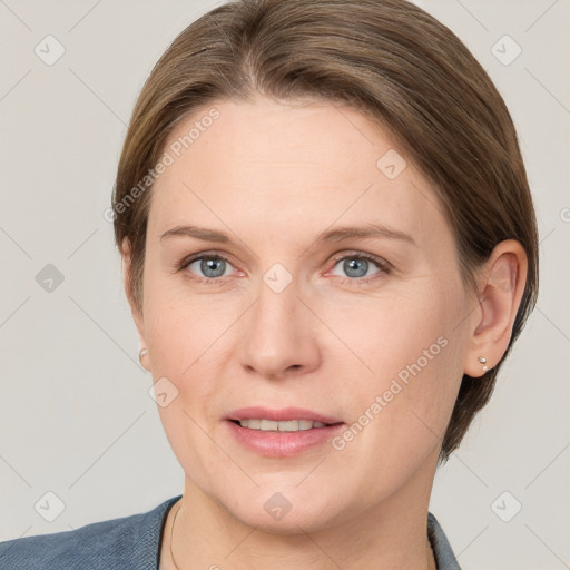 Joyful white adult female with medium  brown hair and grey eyes