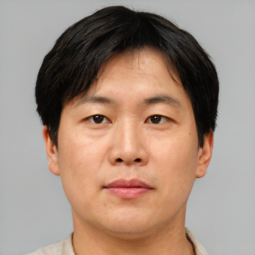 Neutral asian adult male with short  brown hair and brown eyes