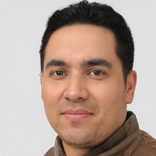 Joyful white young-adult male with short  black hair and brown eyes