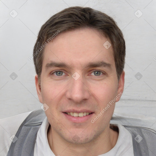 Joyful white young-adult male with short  brown hair and grey eyes