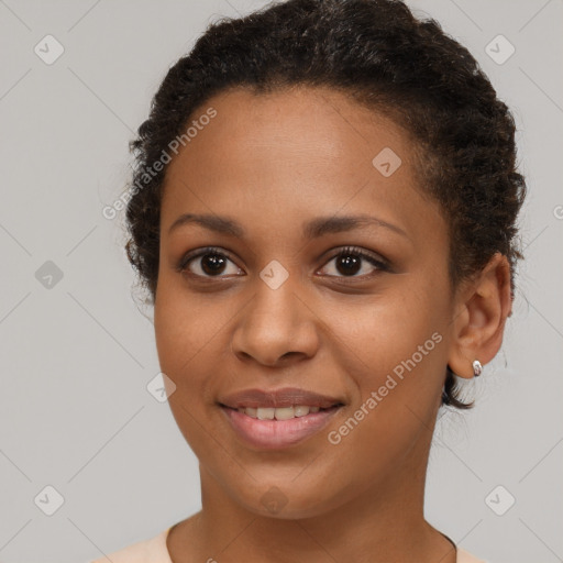 Joyful black young-adult female with short  brown hair and brown eyes