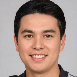 Joyful white young-adult male with short  black hair and brown eyes