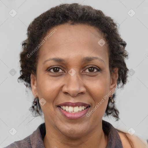 Joyful black adult female with medium  brown hair and brown eyes