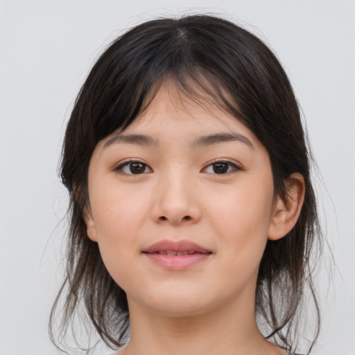 Joyful asian child female with medium  brown hair and brown eyes