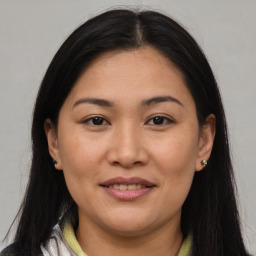 Joyful asian young-adult female with medium  brown hair and brown eyes