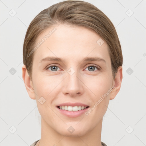 Joyful white young-adult female with short  brown hair and grey eyes