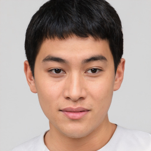Joyful asian young-adult male with short  black hair and brown eyes
