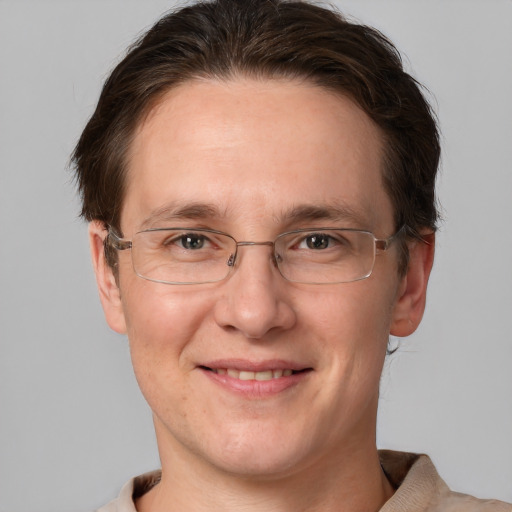 Joyful white adult male with short  brown hair and grey eyes