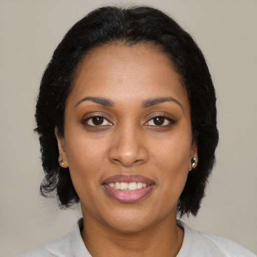 Joyful black young-adult female with medium  black hair and brown eyes