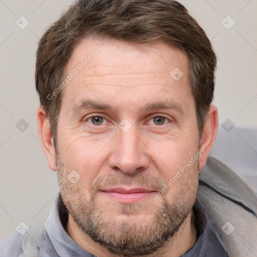 Joyful white adult male with short  brown hair and grey eyes