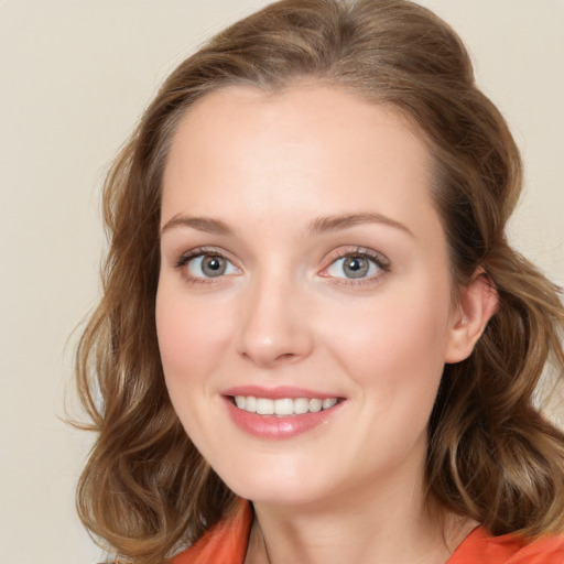 Joyful white young-adult female with long  brown hair and green eyes