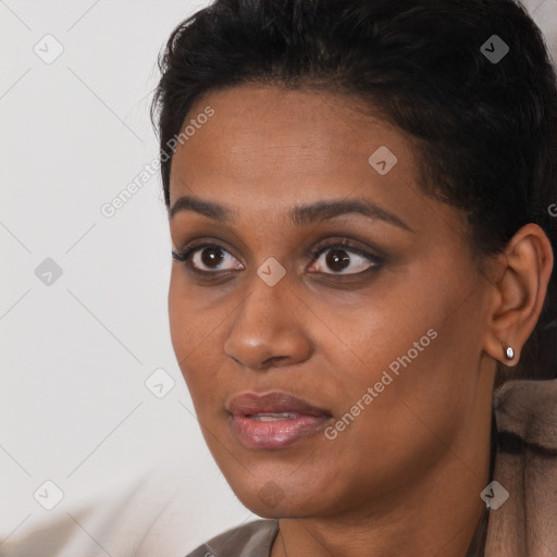 Joyful black young-adult female with short  black hair and brown eyes