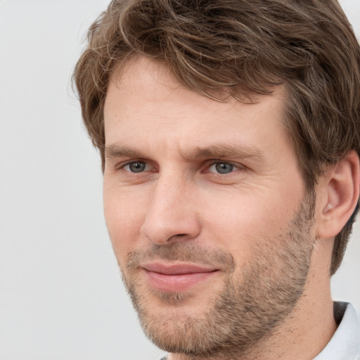 Joyful white adult male with short  brown hair and grey eyes