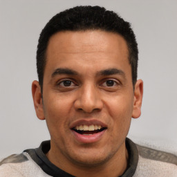 Joyful white young-adult male with short  black hair and brown eyes