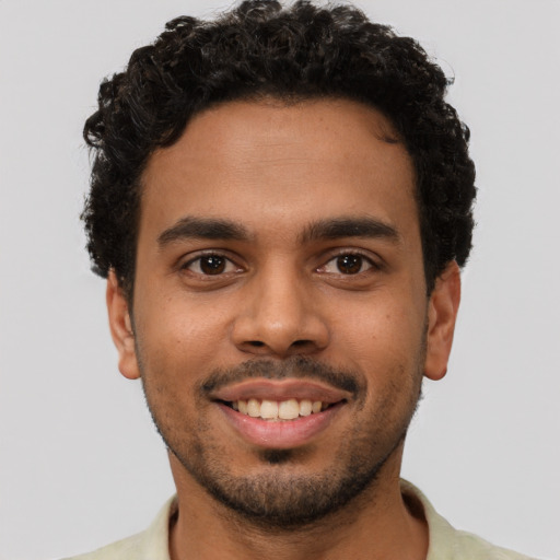 Joyful latino young-adult male with short  brown hair and brown eyes