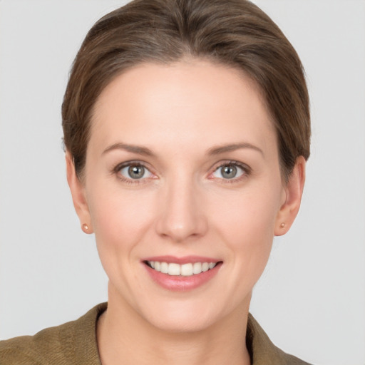 Joyful white young-adult female with short  brown hair and grey eyes