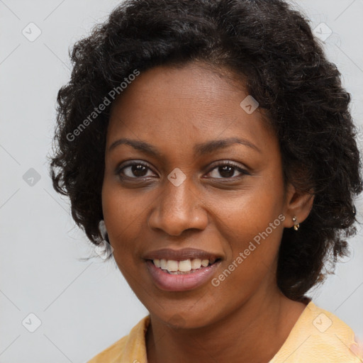 Joyful black young-adult female with long  brown hair and brown eyes