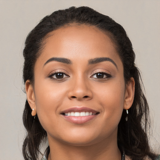 Joyful latino young-adult female with long  black hair and brown eyes