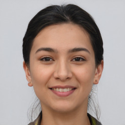 Joyful asian young-adult female with long  brown hair and brown eyes