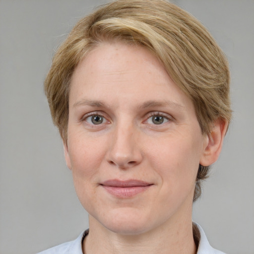 Joyful white adult female with short  brown hair and grey eyes