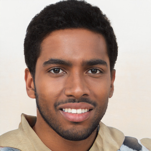 Joyful black young-adult male with short  black hair and brown eyes