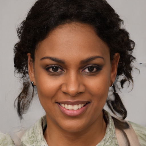 Joyful black young-adult female with medium  brown hair and brown eyes