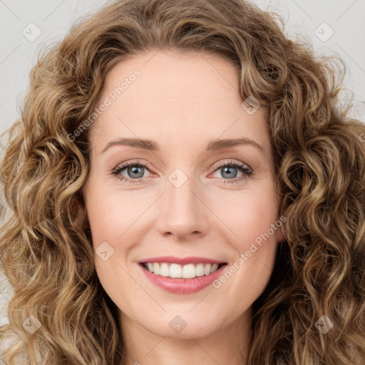 Joyful white young-adult female with long  brown hair and green eyes