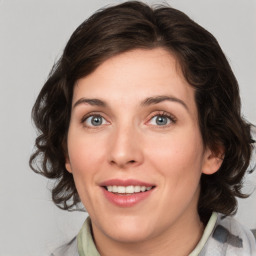 Joyful white young-adult female with medium  brown hair and green eyes