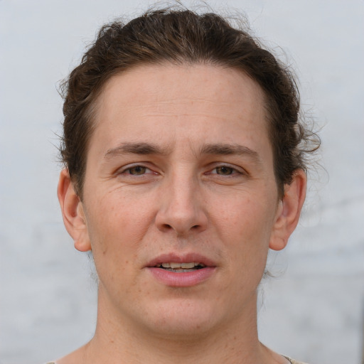 Joyful white adult male with short  brown hair and grey eyes