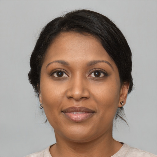Joyful black adult female with short  black hair and brown eyes
