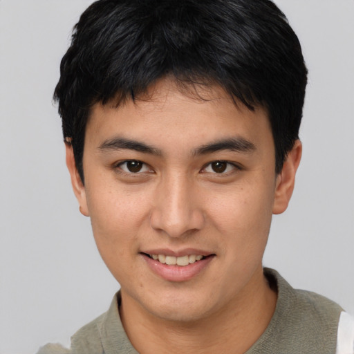 Joyful asian young-adult male with short  brown hair and brown eyes