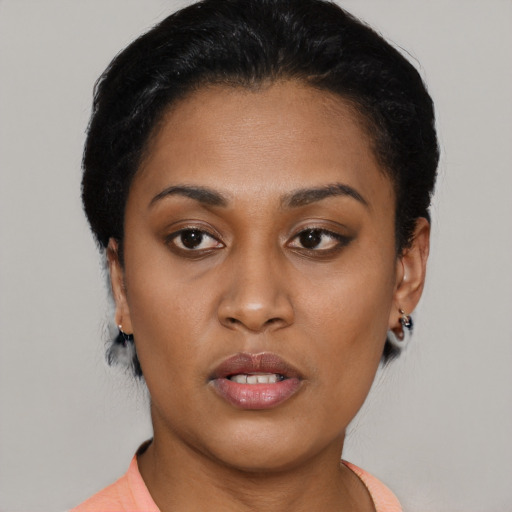 Joyful latino young-adult female with short  black hair and brown eyes