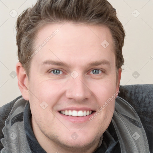 Joyful white young-adult male with short  brown hair and blue eyes