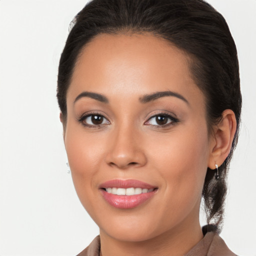 Joyful latino young-adult female with long  brown hair and brown eyes