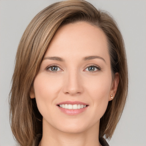 Joyful white young-adult female with long  brown hair and green eyes