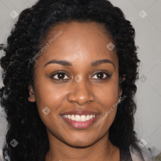 Joyful black young-adult female with long  brown hair and brown eyes