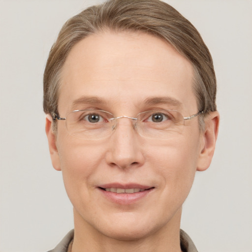 Joyful white adult female with short  brown hair and grey eyes