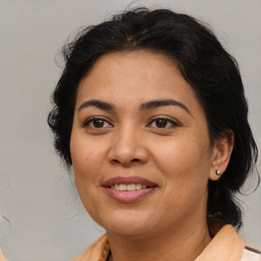 Joyful latino young-adult female with medium  brown hair and brown eyes