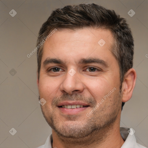 Joyful white adult male with short  brown hair and brown eyes