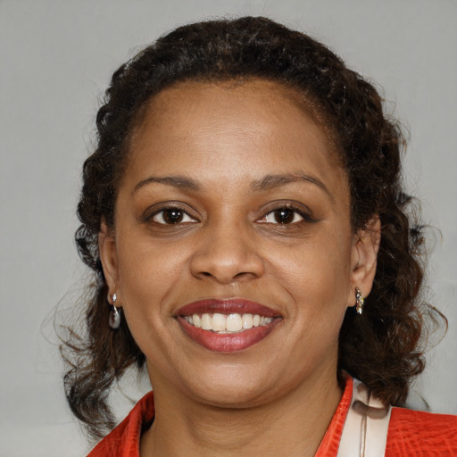 Joyful black young-adult female with medium  brown hair and brown eyes